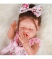 Muñeca tipo bebé reborn con pelo marrón y ojos cerrados
